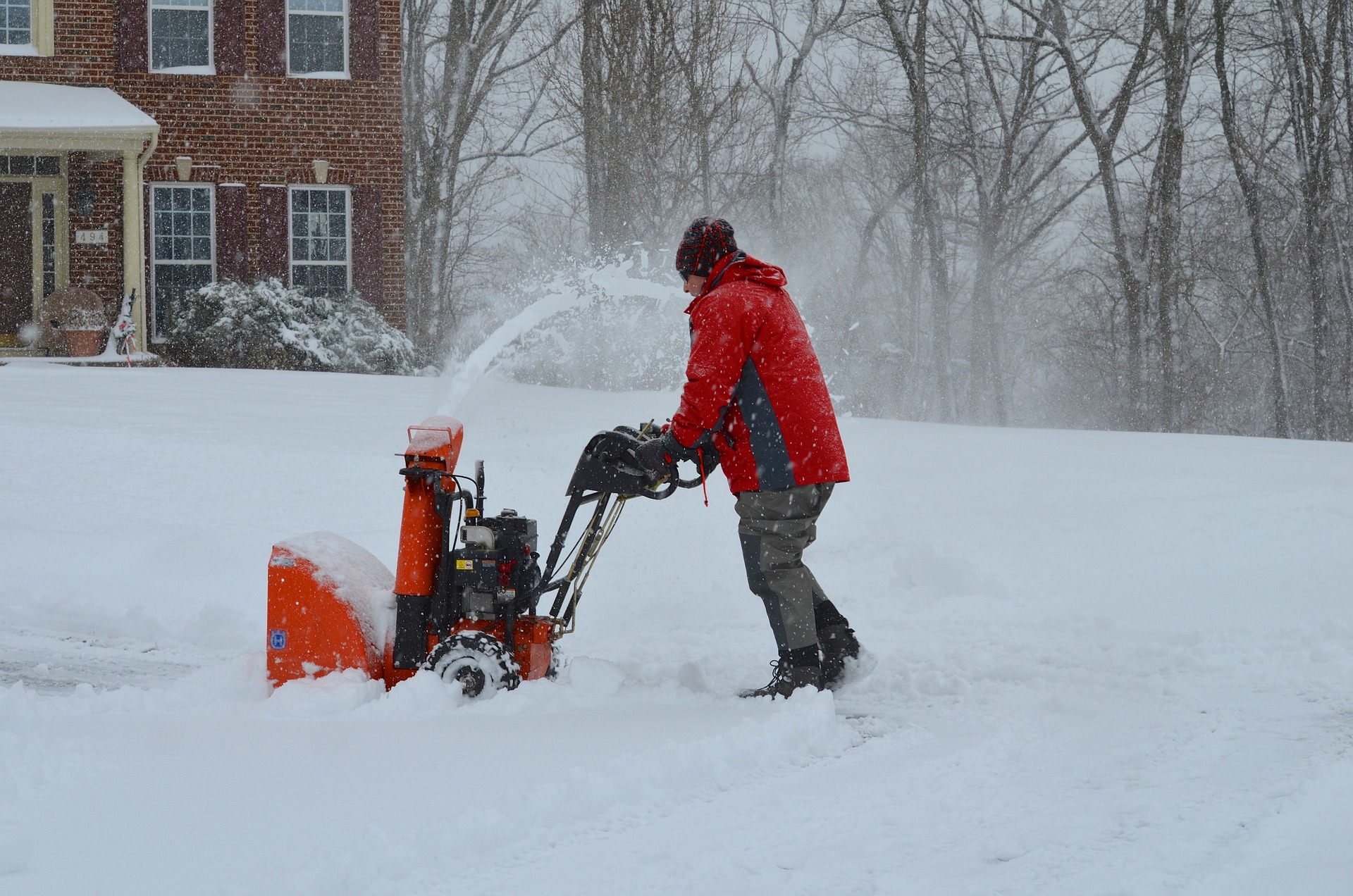 man pushing snowblower